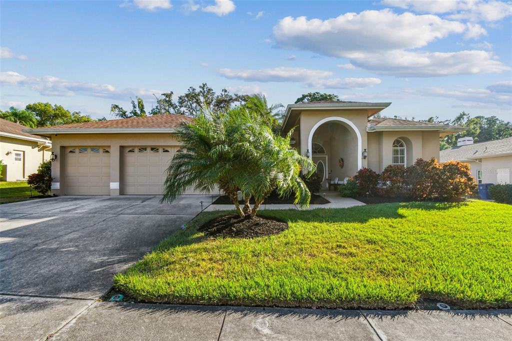 1955 Dunloe Circle Dunedin, FL 34698 - Photo 5 of 94 a front view of a house with garden
