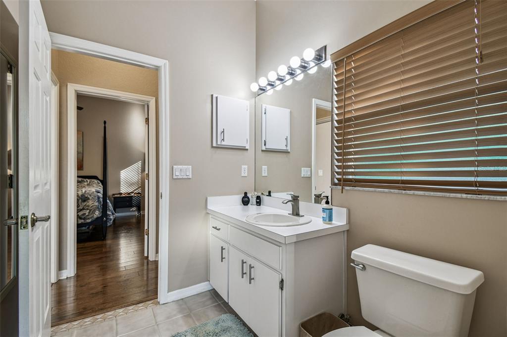 1955 Dunloe Circle Dunedin, FL 34698 - Photo 53 of 94 a bathroom with a double vanity sink toilet and shower