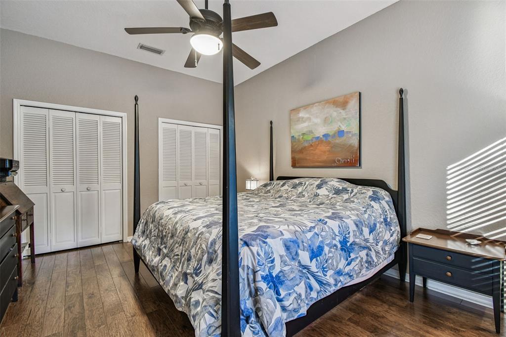 1955 Dunloe Circle Dunedin, FL 34698 - Photo 57 of 94 a bedroom with a large bed and a chandelier