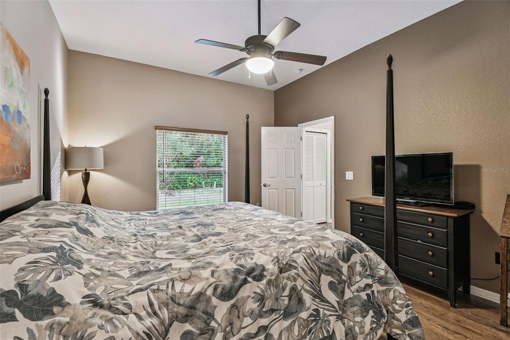 1955 Dunloe Circle Dunedin, FL 34698 - Photo 60 of 94 a bedroom with a bed and a flat screen tv