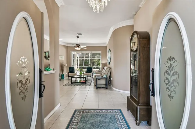 a view of a dining room with furniture a chandelier and window