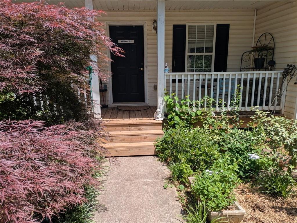 435 Red Oak Court Monroe, GA 30655 - Photo 2 of 28 a view of small house with yard and plants