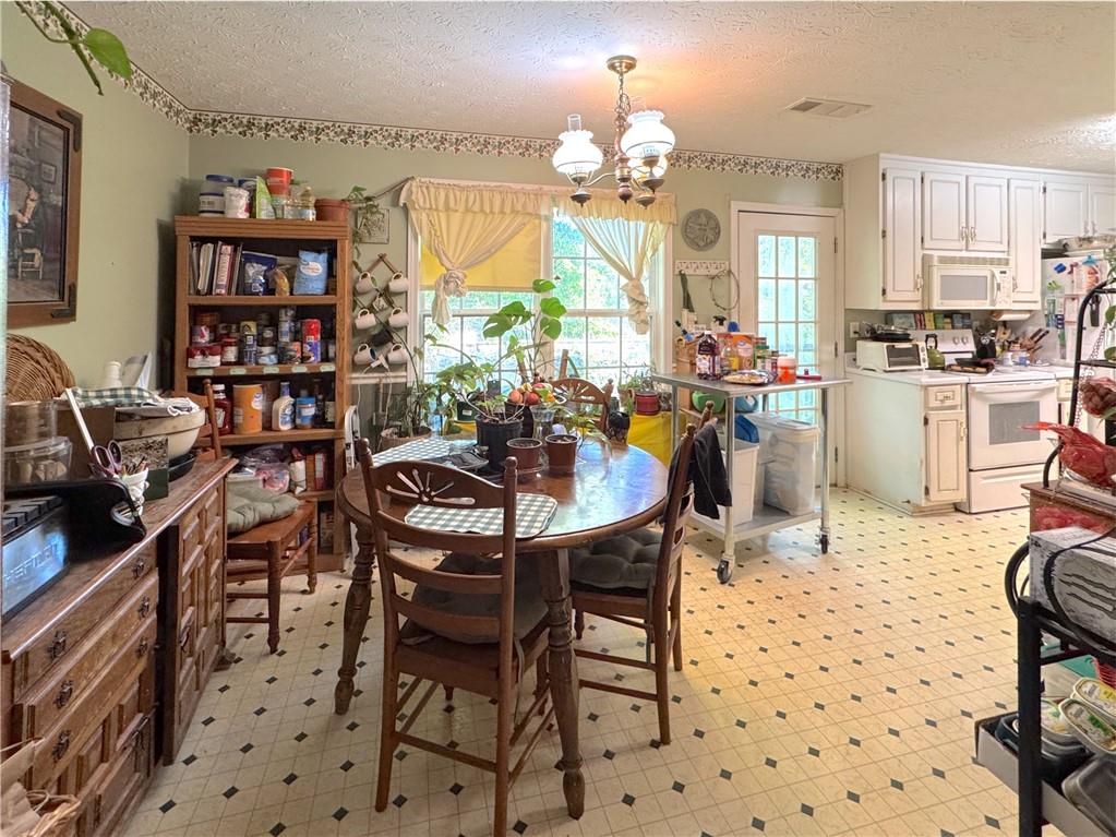435 Red Oak Court Monroe, GA 30655 - Photo 7 of 28 a view of a dining room with furniture and chandelier