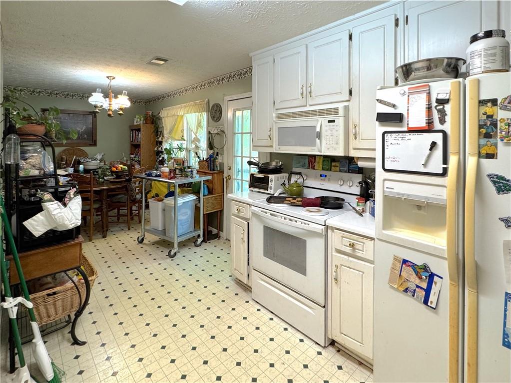 435 Red Oak Court Monroe, GA 30655 - Photo 8 of 28 a kitchen with a sink and white cabinets
