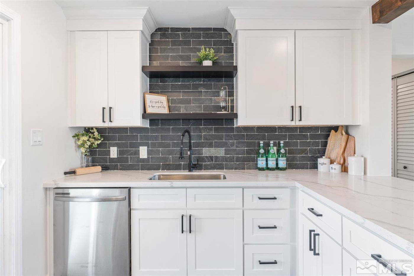 a kitchen with stainless steel appliances white cabinets and a sink