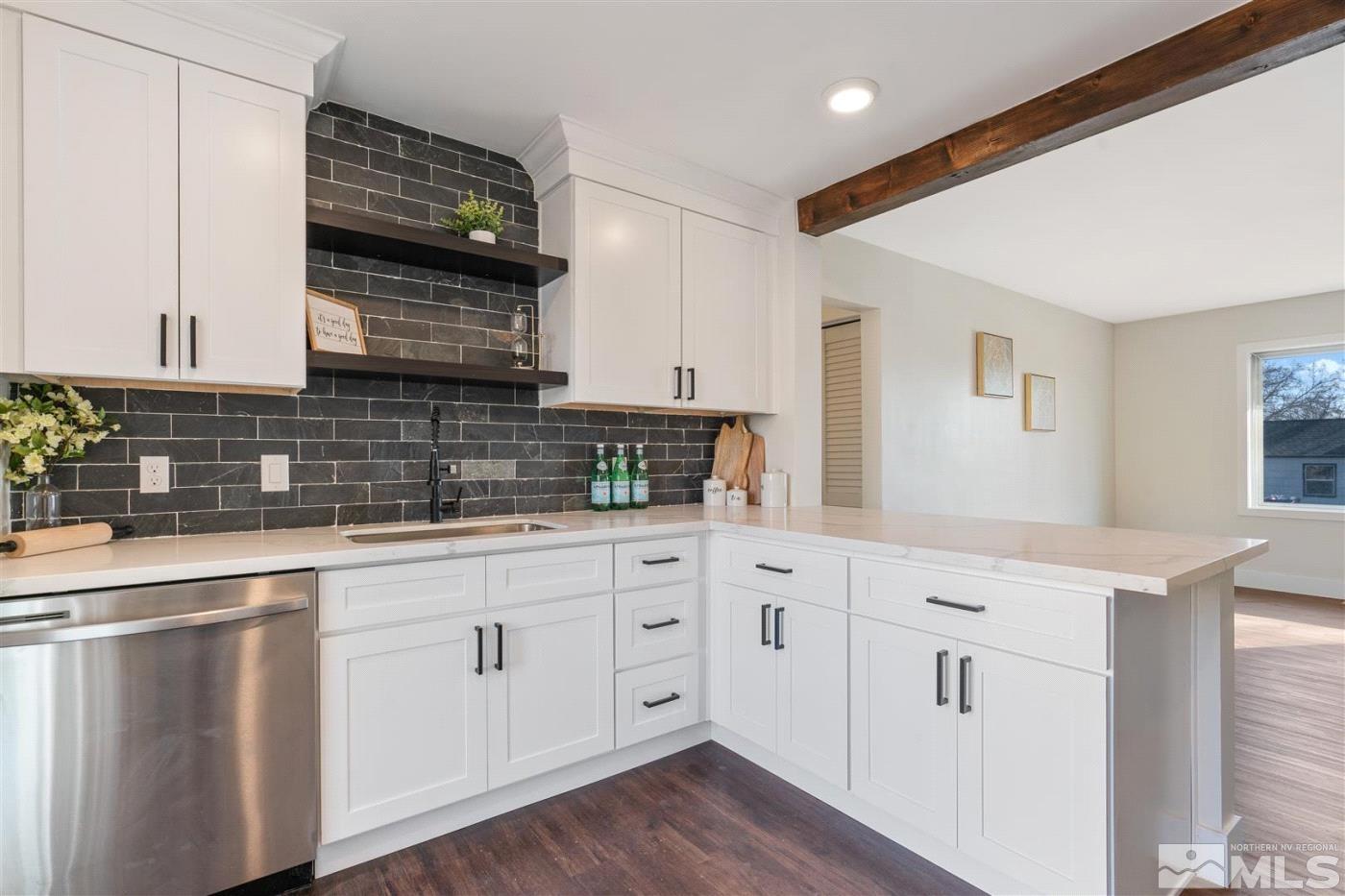 289 Bartlett Street Reno, NV 89512 - Photo 12 of 40 a kitchen with white cabinets and sink