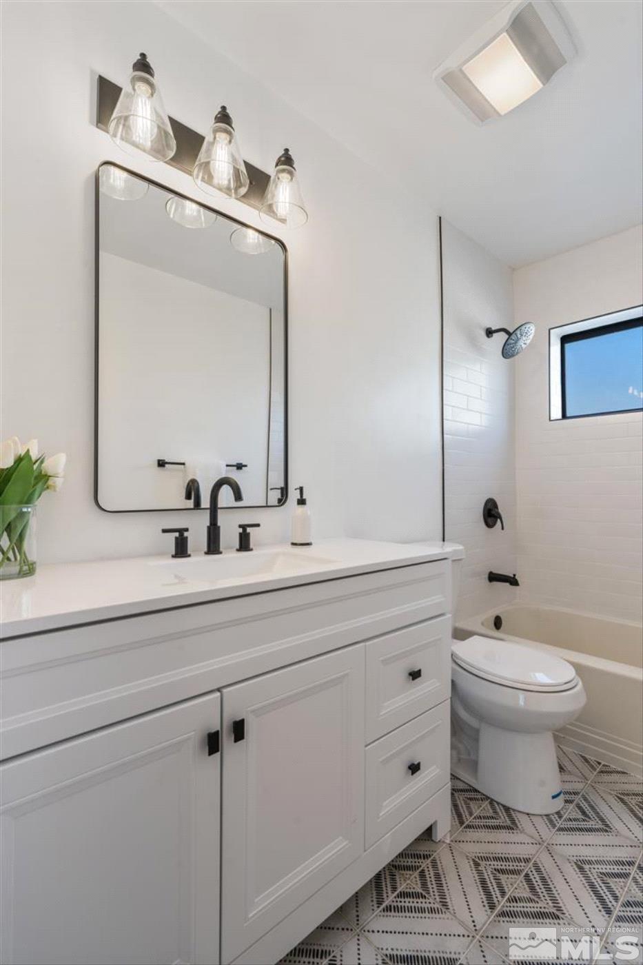 289 Bartlett Street Reno, NV 89512 - Photo 13 of 40 a bathroom with a toilet a sink and mirror