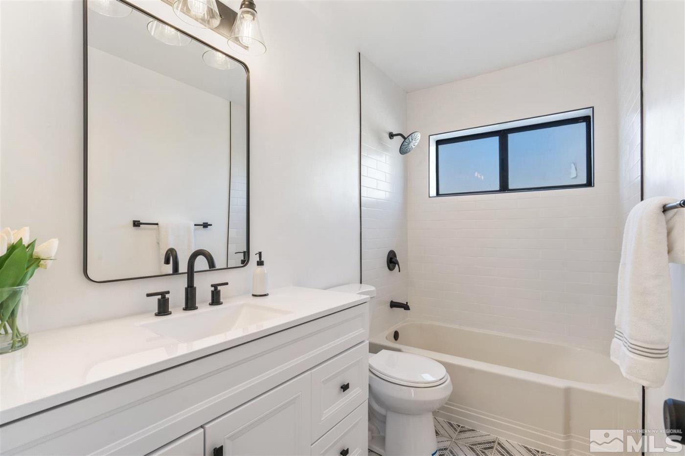 289 Bartlett Street Reno, NV 89512 - Photo 14 of 40 a bathroom with a sink a toilet a mirror and shower