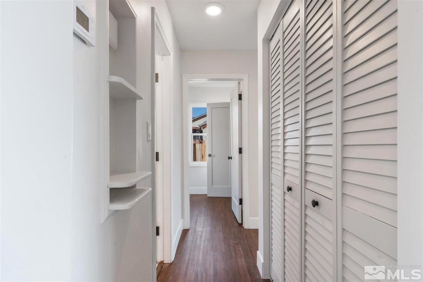 289 Bartlett Street Reno, NV 89512 - Photo 16 of 40 a view of a hallway with wooden floor