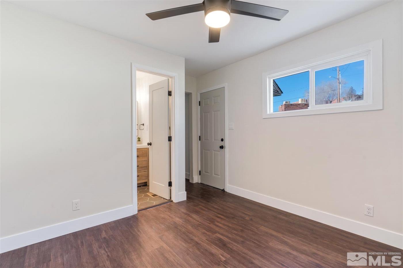 289 Bartlett Street Reno, NV 89512 - Photo 17 of 40 an empty room with wooden floor and a ceiling fan