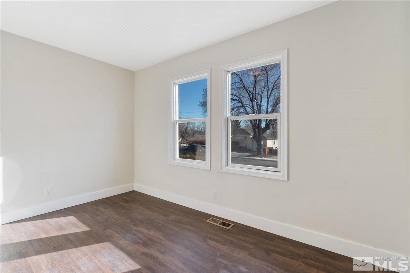 289 Bartlett Street Reno, NV 89512 - Photo 20 of 40 a view of an empty room with wooden floor and a window