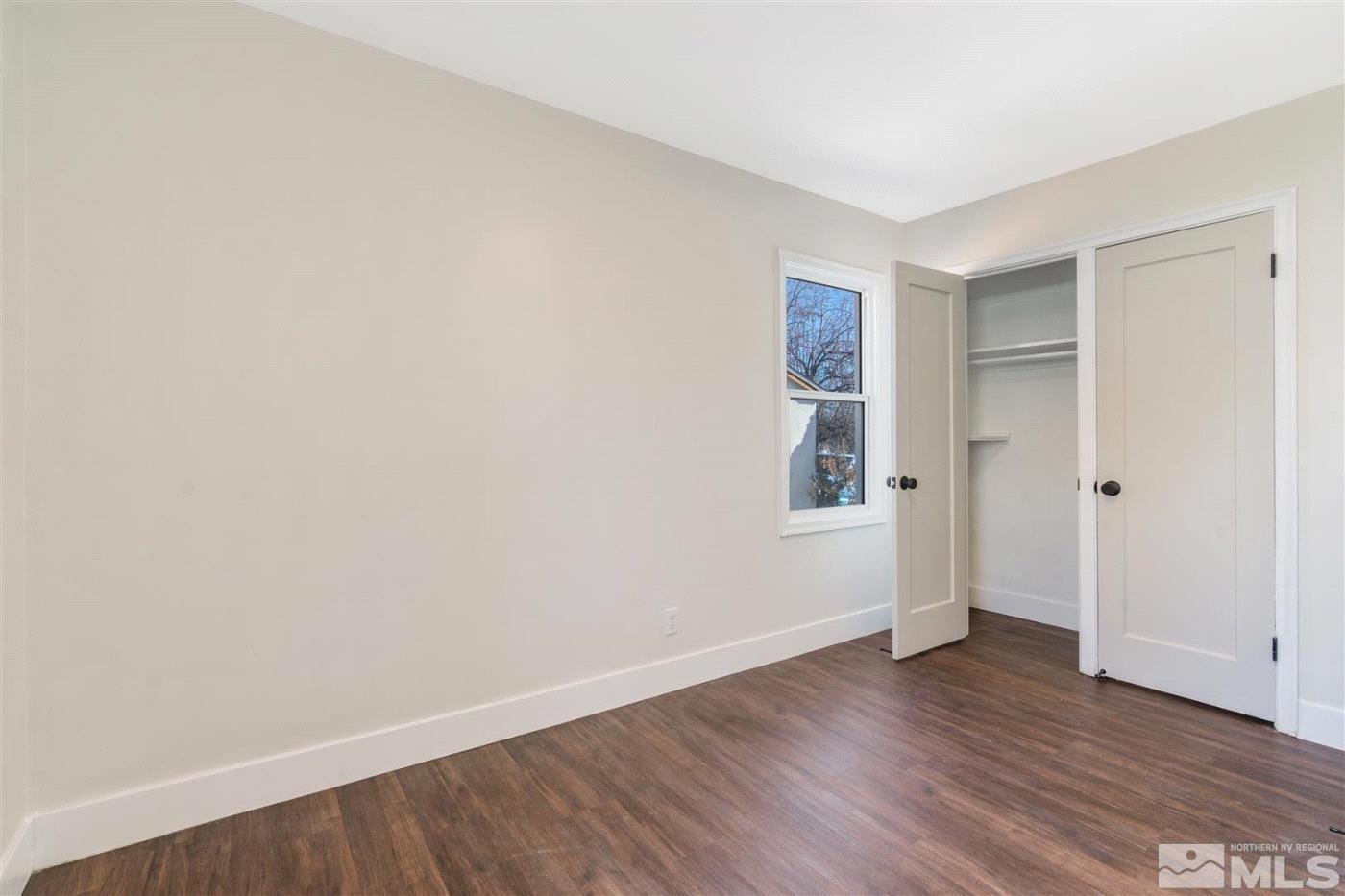 289 Bartlett Street Reno, NV 89512 - Photo 23 of 40 a view of an empty room with wooden floor and closet