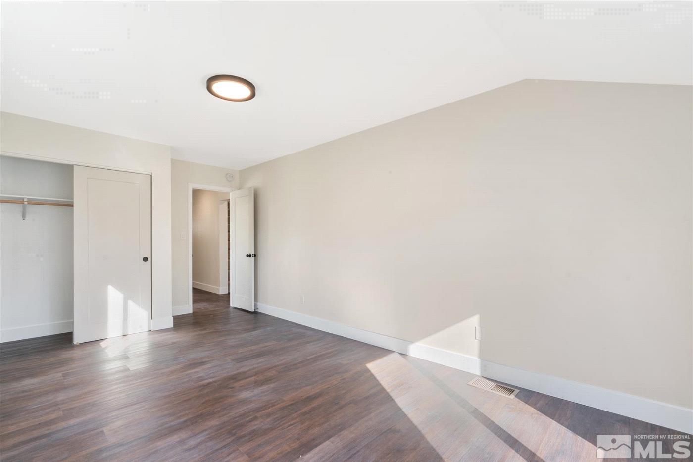 289 Bartlett Street Reno, NV 89512 - Photo 25 of 40 a view of an empty room with wooden floor