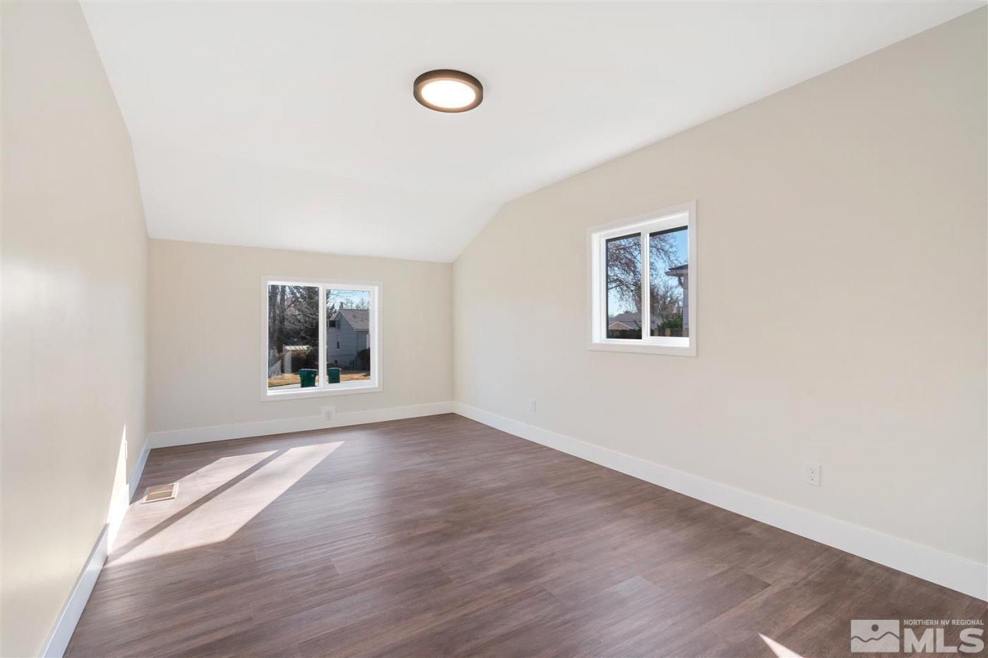 289 Bartlett Street Reno, NV 89512 - Photo 26 of 40 an empty room with wooden floor and windows