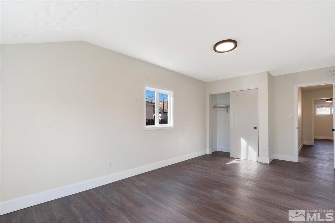 289 Bartlett Street Reno, NV 89512 - Photo 27 of 40 an empty room with wooden floor and windows