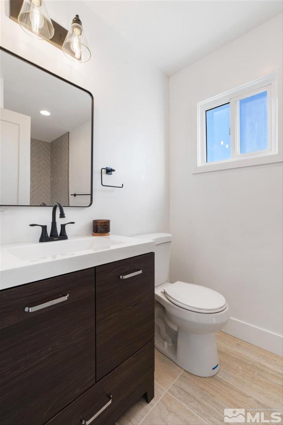 289 Bartlett Street Reno, NV 89512 - Photo 28 of 40 a bathroom with a toilet sink and mirror