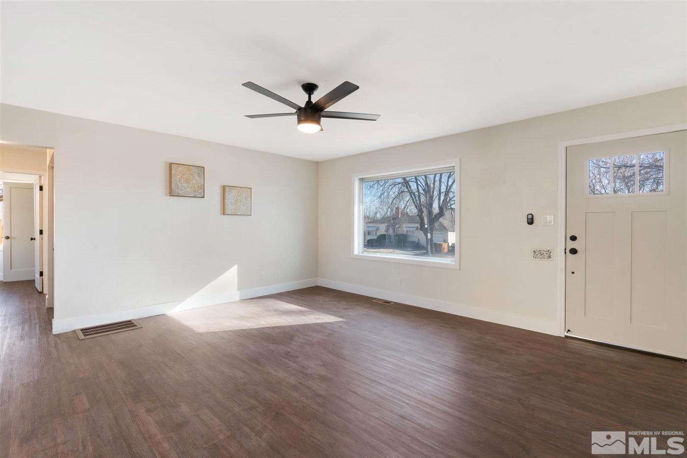 289 Bartlett Street Reno, NV 89512 - Photo 6 of 40 a view of a big room with wooden floor and windows in a room