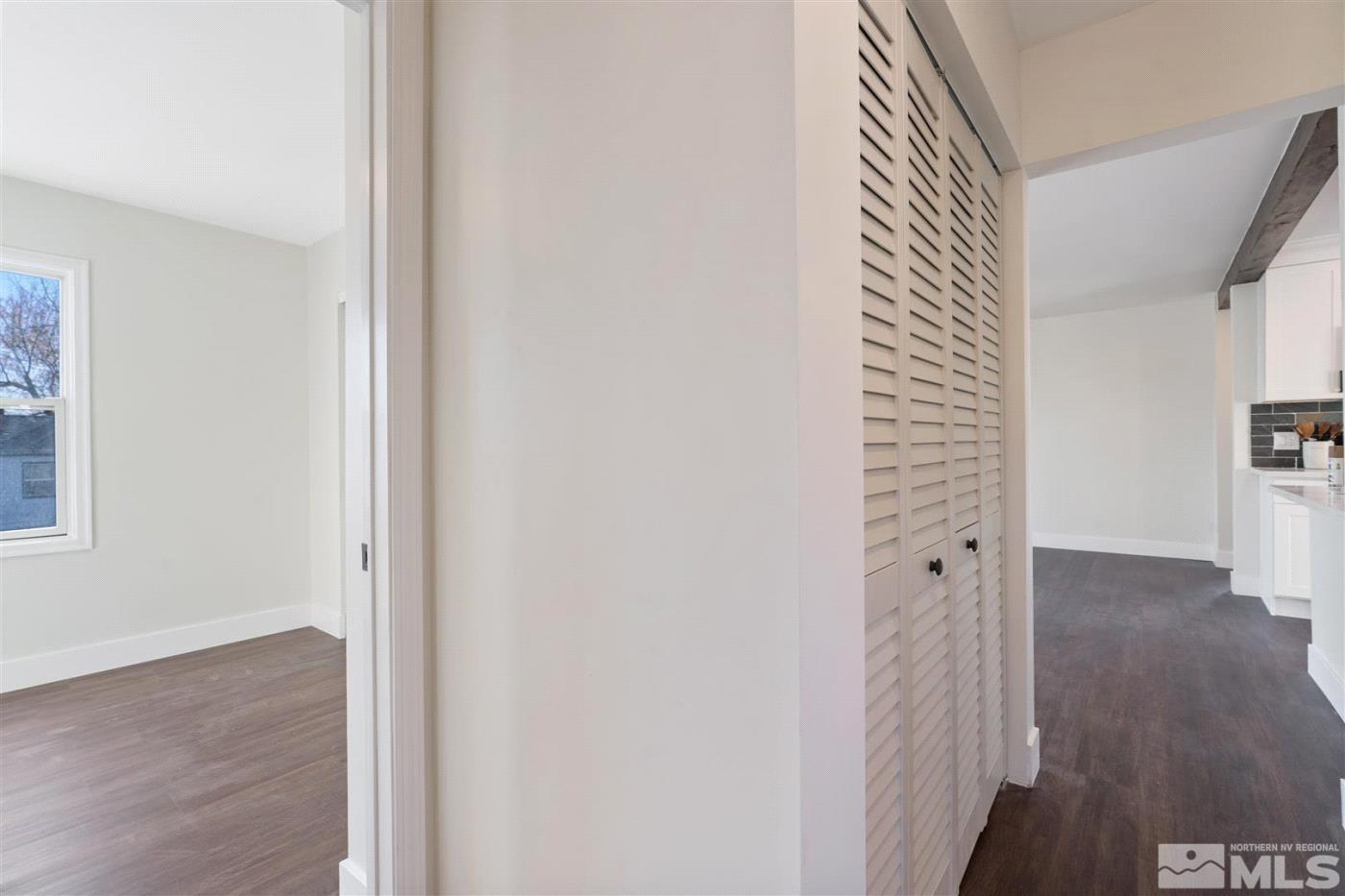 289 Bartlett Street Reno, NV 89512 - Photo 7 of 40 a view of a hallway with wooden floor and a bathroom