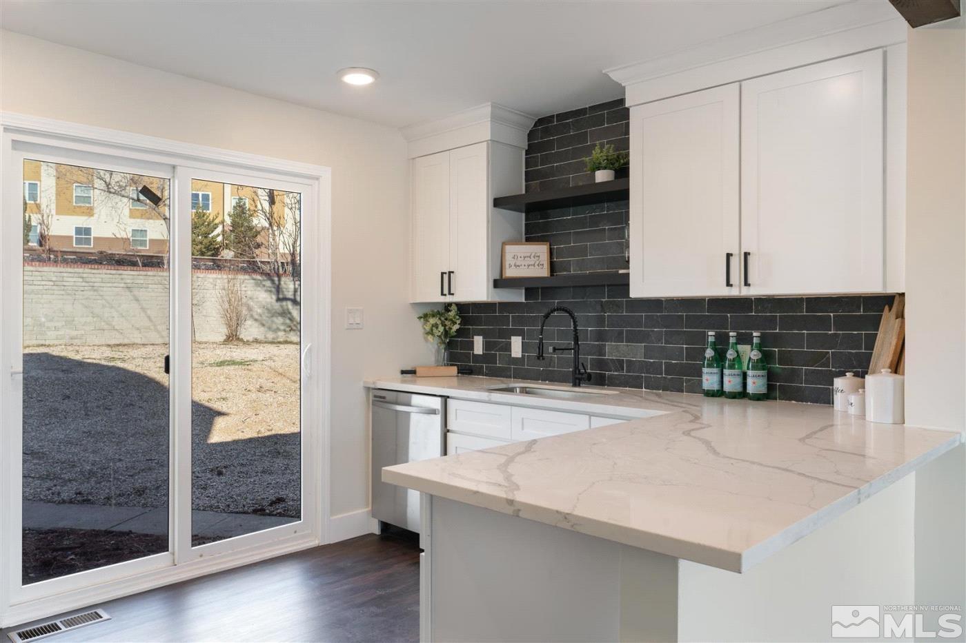 289 Bartlett Street Reno, NV 89512 - Photo 8 of 40 a kitchen with a sink and a refrigerator