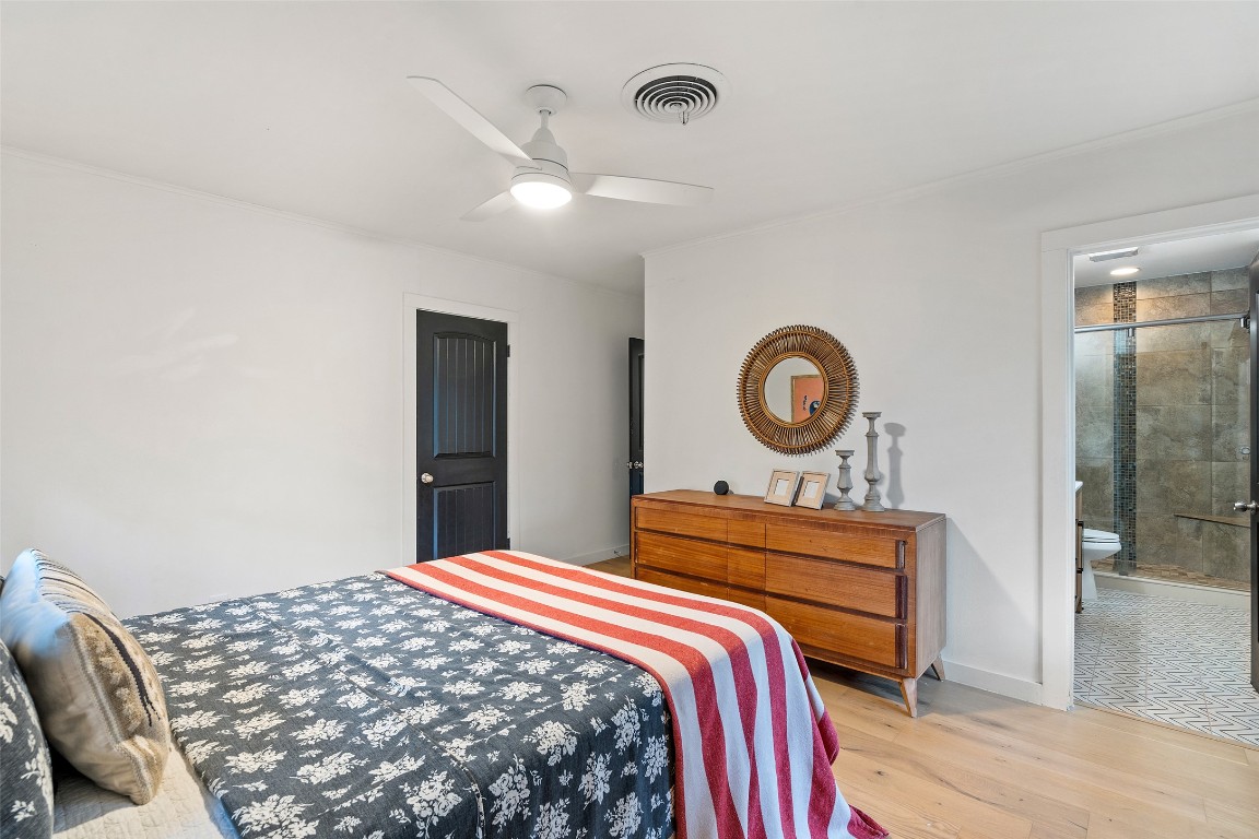 1802 Hutto Road Georgetown, TX 78626 - Photo 15 of 33 a bedroom with a bed and a chandelier