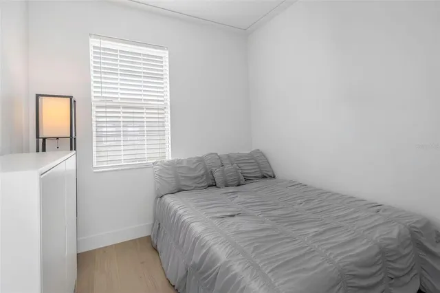 a large bed sitting in a bedroom next to a window