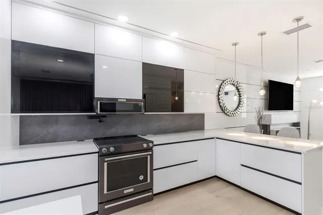 a kitchen with stainless steel appliances granite countertop a sink and a stove top oven