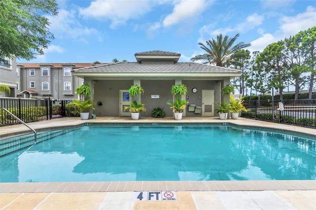 a view of swimming pool with outdoor seating and a garden