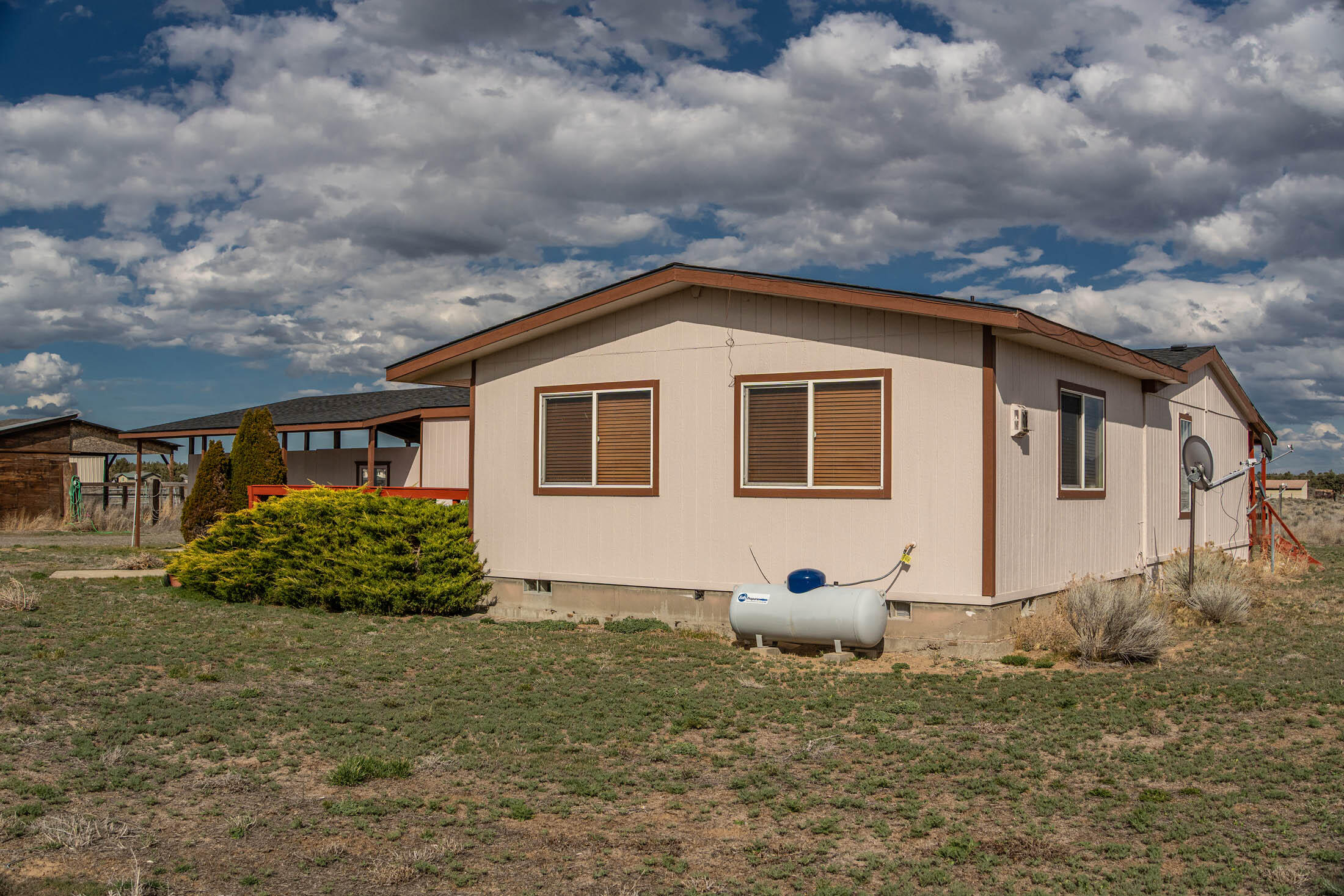 25907 South Cooper Street Bend, OR 97701 - Photo 32 of 34 a view of a white house with a yard