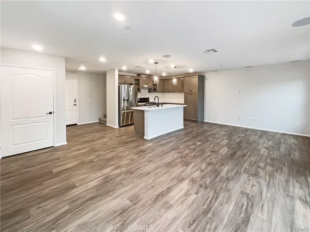 a large kitchen with kitchen island a sink stainless steel appliances and cabinets