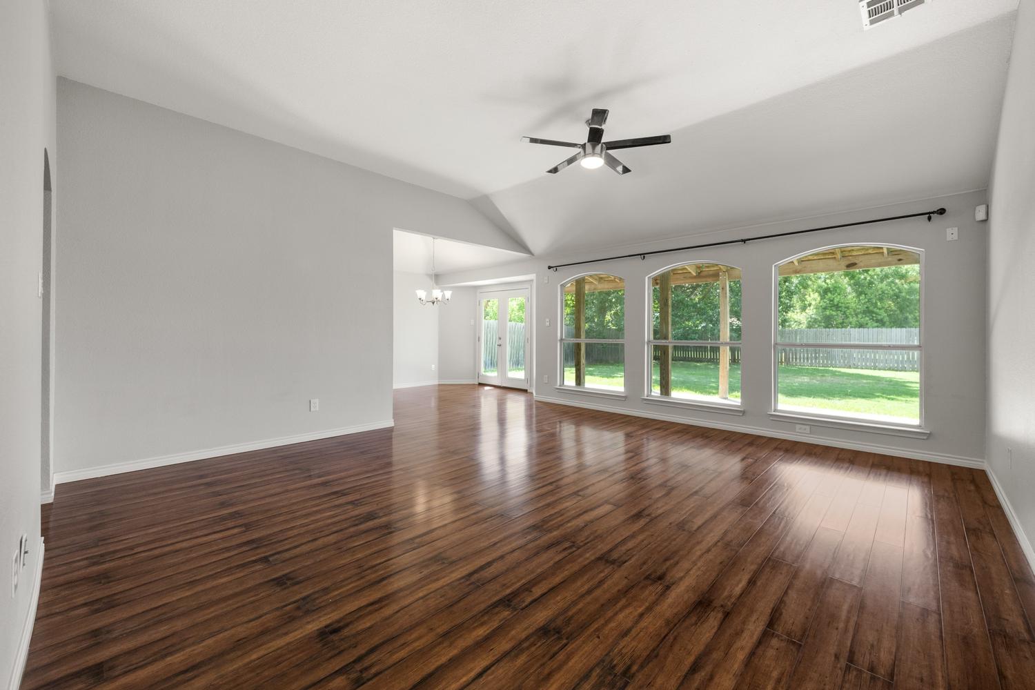 521 Britni Loop Kyle, TX 78640 - Photo 5 of 23 a view of empty room with wooden floor and fan