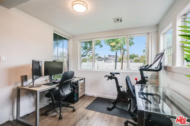 a view of a workspace with furniture and a window