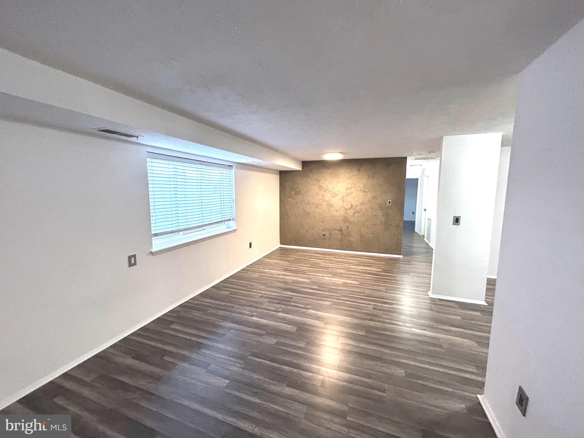 12405 Hickory Tree Way, Unit 613 Germantown, MD 20874 - Photo 11 of 39 a view of empty room with wooden floor and fan