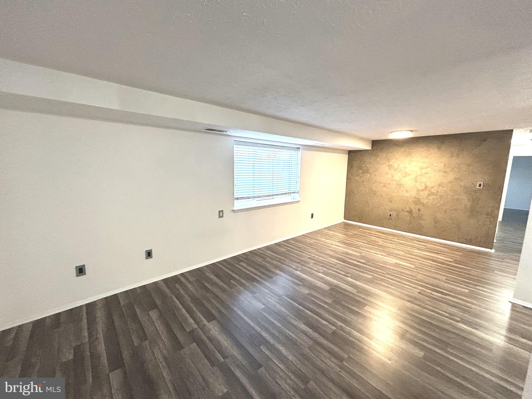 12405 Hickory Tree Way, Unit 613 Germantown, MD 20874 - Photo 14 of 39 a view of empty room with wooden floor and fan
