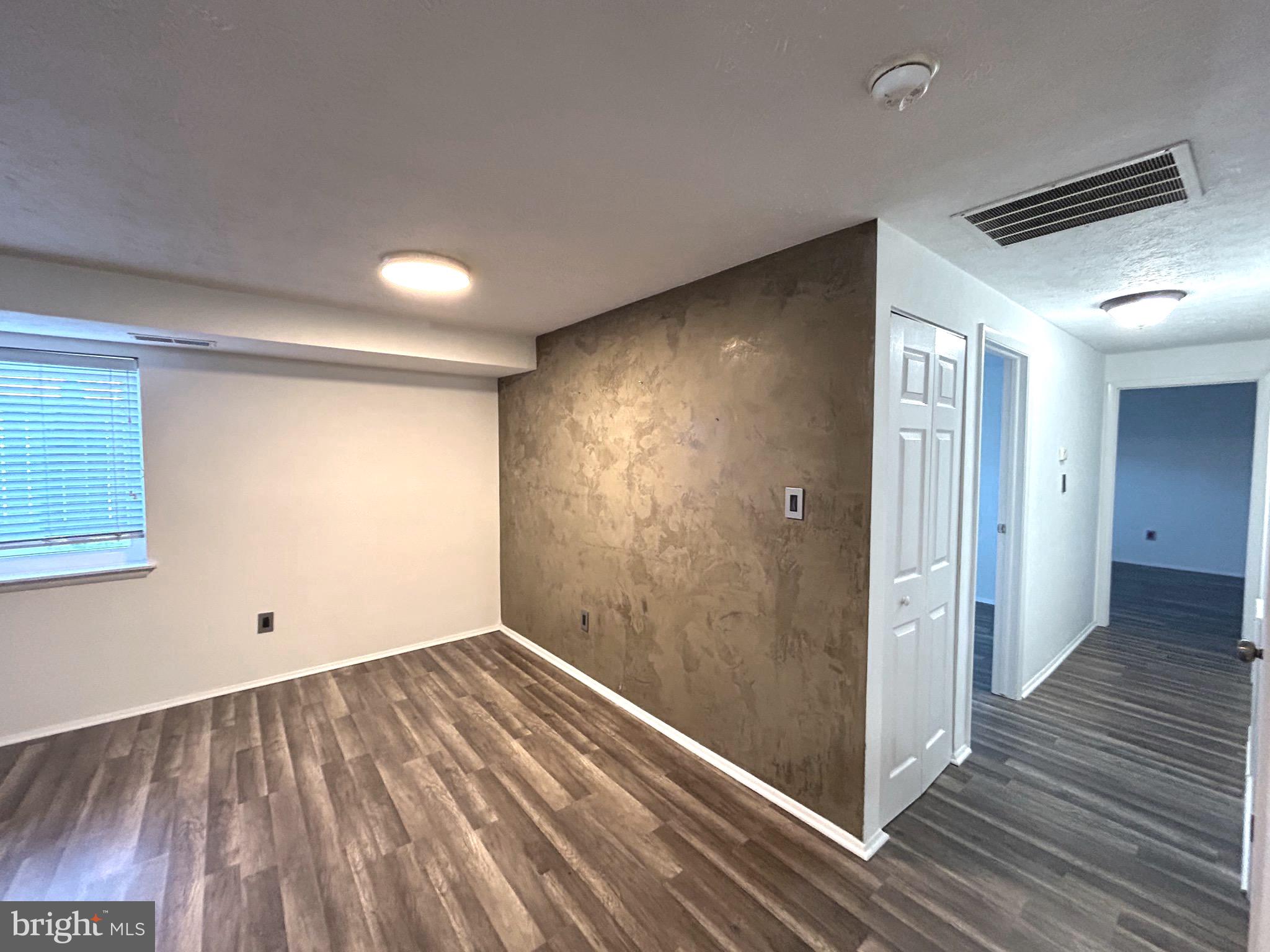 12405 Hickory Tree Way, Unit 613 Germantown, MD 20874 - Photo 16 of 39 an empty room with wooden floor and windows