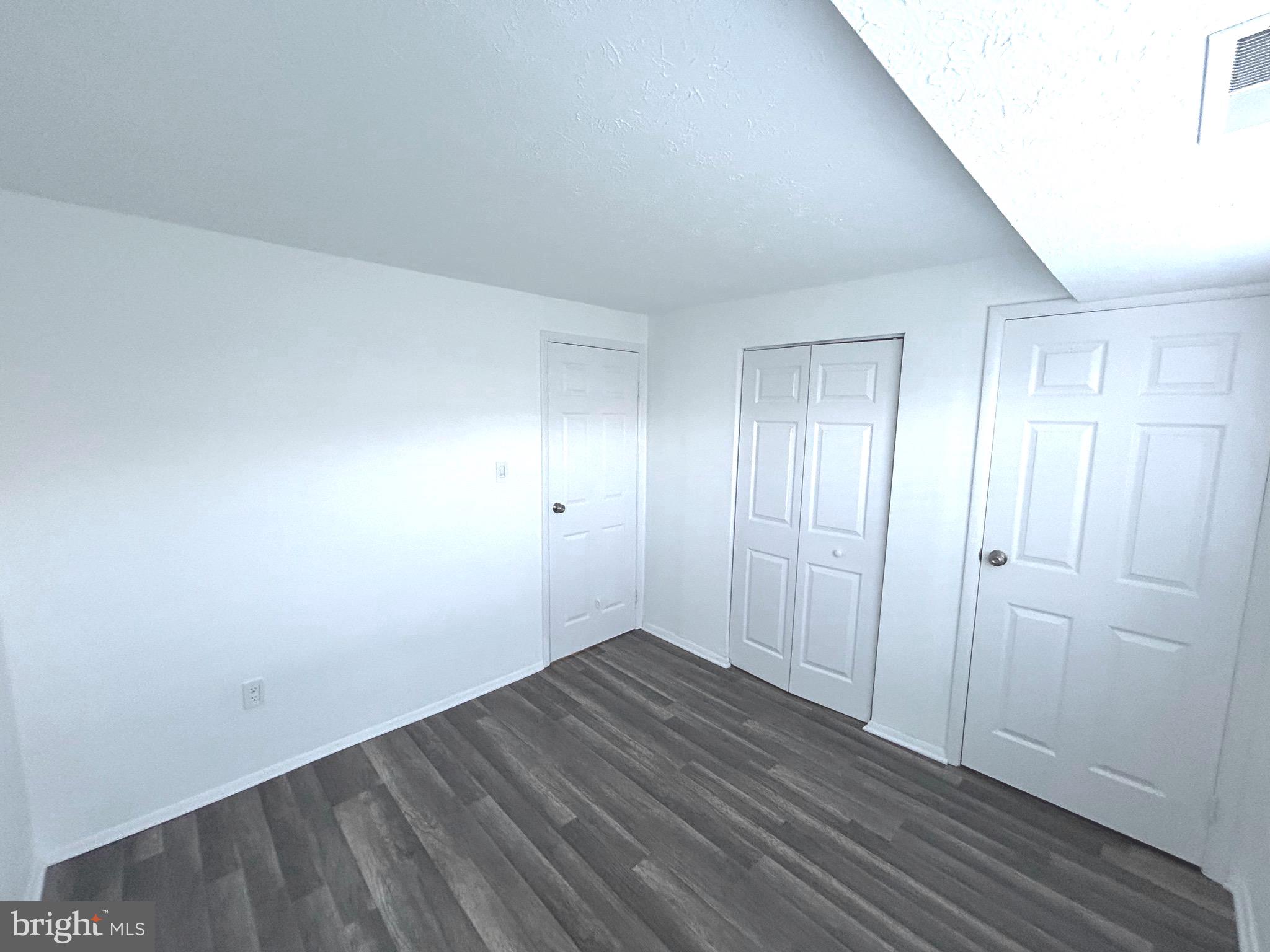 12405 Hickory Tree Way, Unit 613 Germantown, MD 20874 - Photo 23 of 39 a view of an empty room with wooden floor