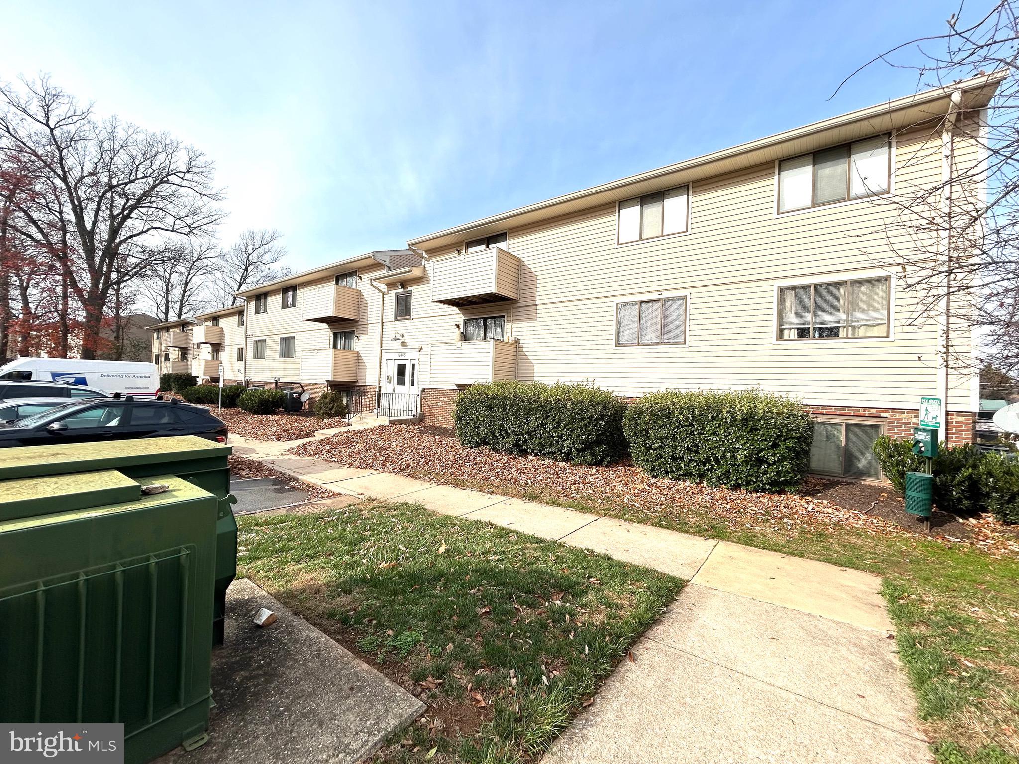 12405 Hickory Tree Way, Unit 613 Germantown, MD 20874 - Photo 3 of 39 a front view of a house with a yard
