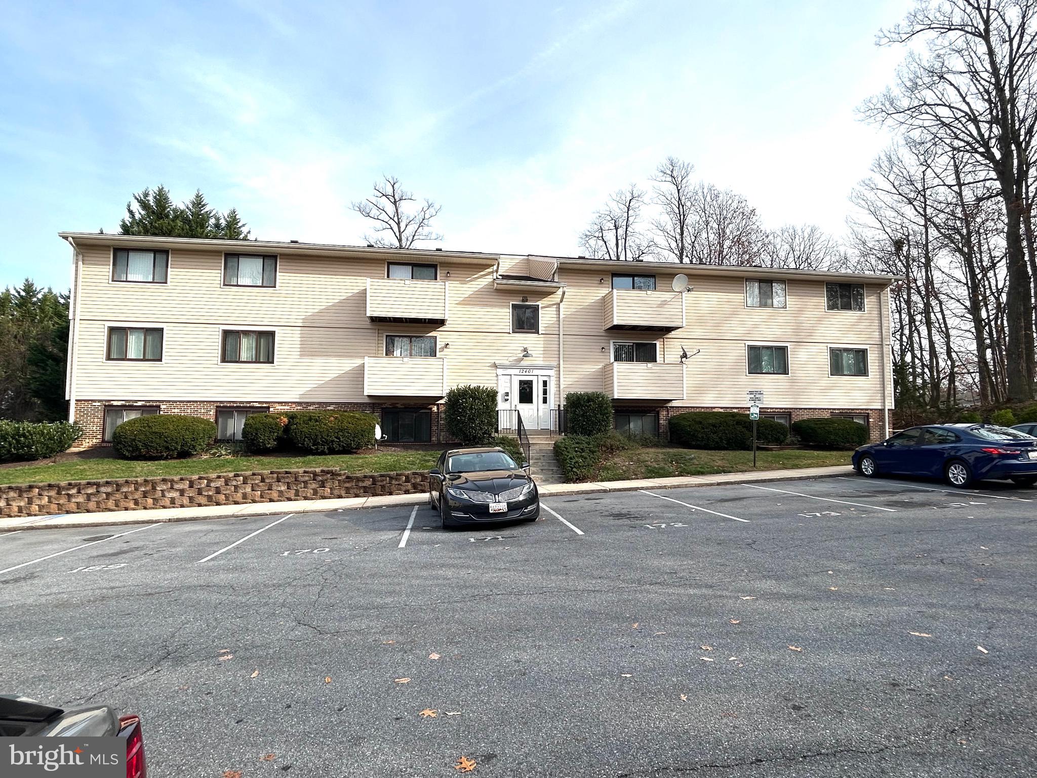 12405 Hickory Tree Way, Unit 613 Germantown, MD 20874 - Photo 3 of 22 a car parked in front of a white house