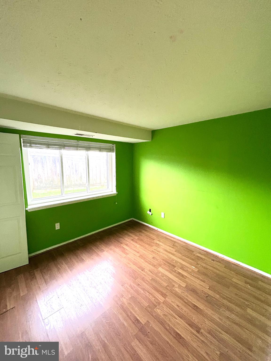 12405 Hickory Tree Way, Unit 613 Germantown, MD 20874 - Photo 38 of 39 a view of a room with wooden floor and windows