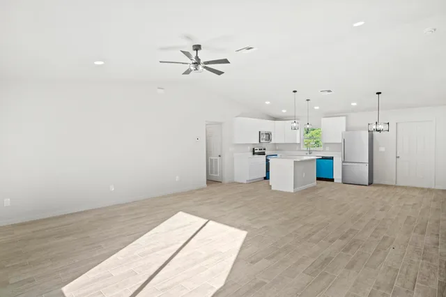 a view of a kitchen with a sink and a window