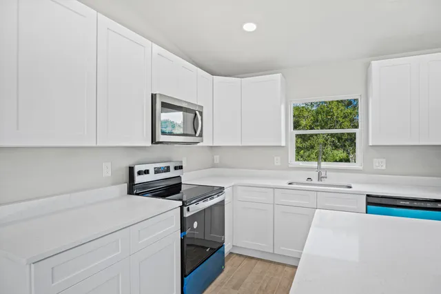 a kitchen with refrigerator and cabinets