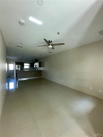 an empty room with projector and windows