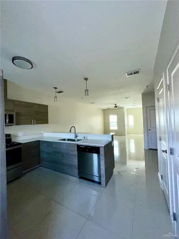 a large kitchen with a stove and cabinets