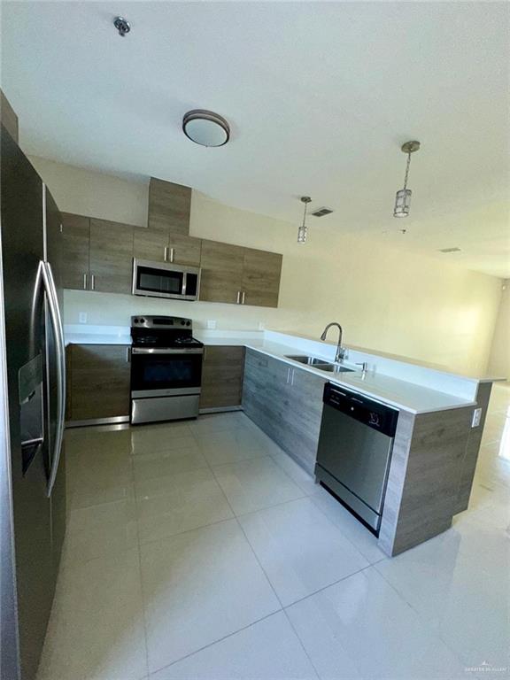 418 Newport Avenue, Unit 2 Edinburg, TX 78539 - Photo 7 of 18 a kitchen with stainless steel appliances a stove a sink and white cabinets