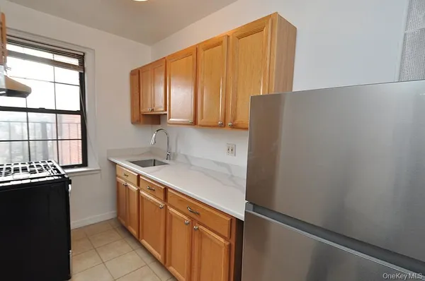 a kitchen with a sink and a refrigerator