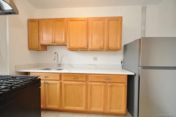 a kitchen with a refrigerator stove and sink