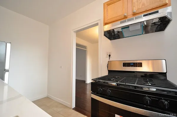 a stove top oven sitting inside of a kitchen