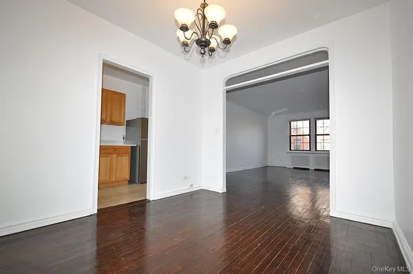 a view of livingroom with chandelier and wooden floor