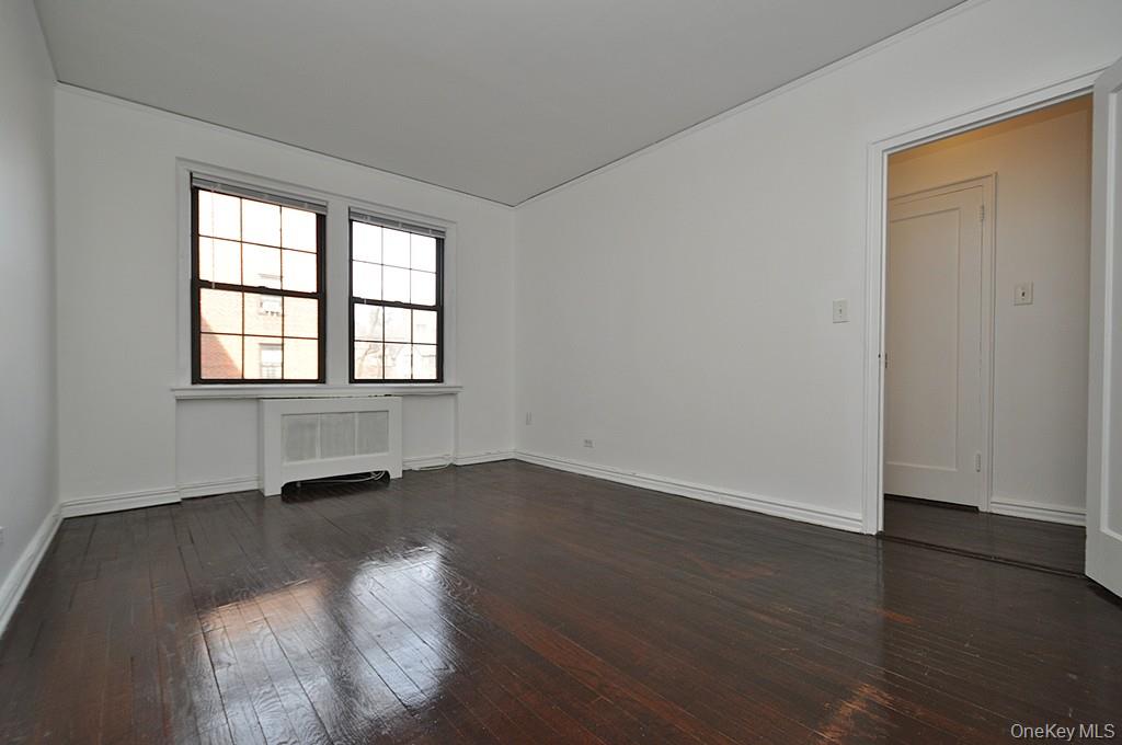 180 Garth Road, Unit 4F Scarsdale, NY 10583 - Photo 21 of 39 Bedroom overlooks the manicured courtyard and has hardwood floors. The bedroom is approx. 14'-10" x 10'-11".