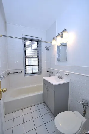 a bathroom with a sink a toilet and bathtub