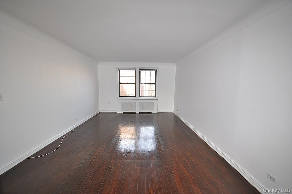 180 Garth Road, Unit 4F Scarsdale, NY 10583 - Photo 6 of 39 The large living room has hardwood floors, overlooks the manicured courtyard and opens to the dining room. The living room is approx. 19'-9" x 12'7".